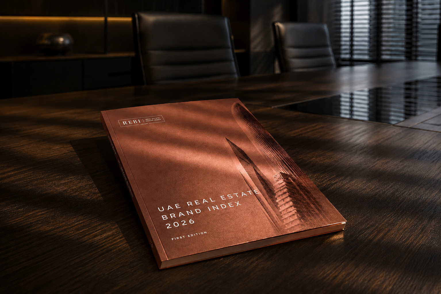 REBI UAE 2026 Professional Report front cover on a boardroom table